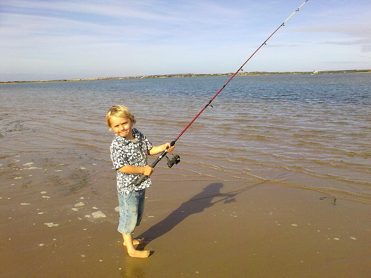 Young angler fishing from the shore near the Murray Mouth in South Australia