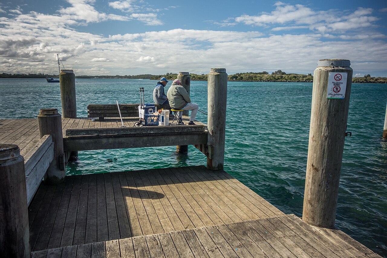 People fishing from a wharf in Port Macquarie, New South Wales